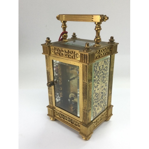 636 - A brass cased carriage clock with engraved front. Comes supplied with keys. Shipping category D.