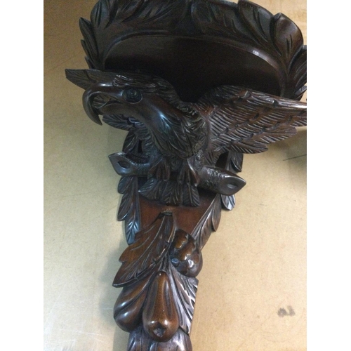 643 - A pair of carved wall brackets in the form of eagles. 34 cm