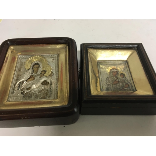 646 - A gilt and enamel icon together with two cased icons .