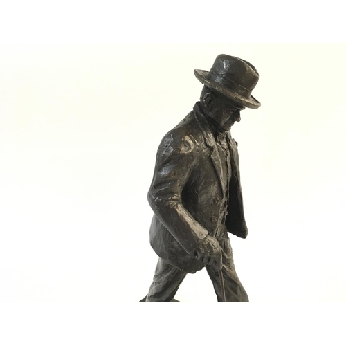 668 - Solid bronze statue of Winston Churchill walking along with a walking stick. Signature to base possi... 