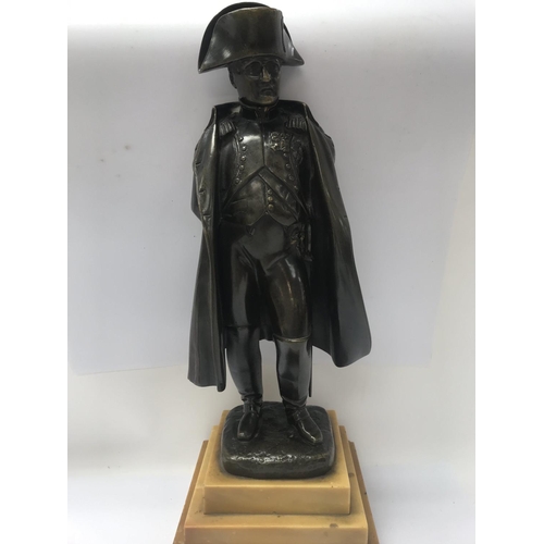 671 - A bronze figure of Napoleon on a stepped marble base. 36cm in height