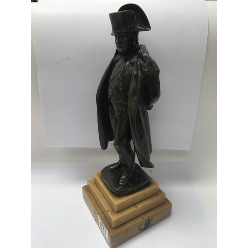 671 - A bronze figure of Napoleon on a stepped marble base. 36cm in height