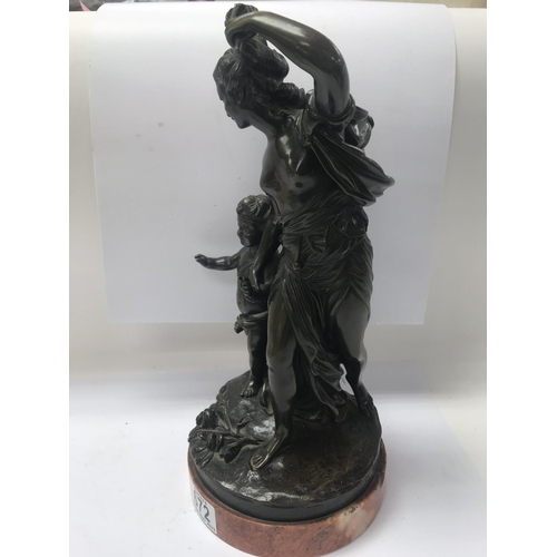 672 - A bronze figure group in classical form depicting maiden and cherub, on a marble base. 35cm in heigh... 