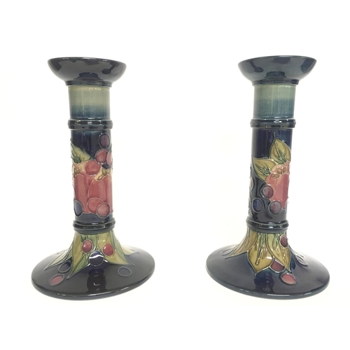 806 - A pair of boxed Moorcroft Finch & Berries candlesticks. 21cm tall. no obvious large damage or restor... 