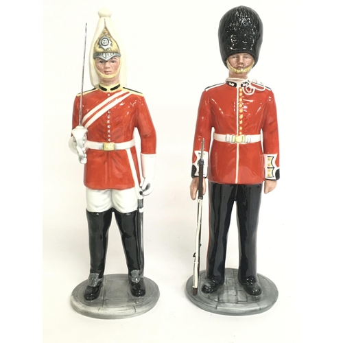 818 - Royal Doulton The Guardsman & The Lifeguard porcelain figures. Approximately 15cm tall. Postage cate... 