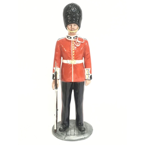 818 - Royal Doulton The Guardsman & The Lifeguard porcelain figures. Approximately 15cm tall. Postage cate... 