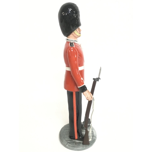 818 - Royal Doulton The Guardsman & The Lifeguard porcelain figures. Approximately 15cm tall. Postage cate... 