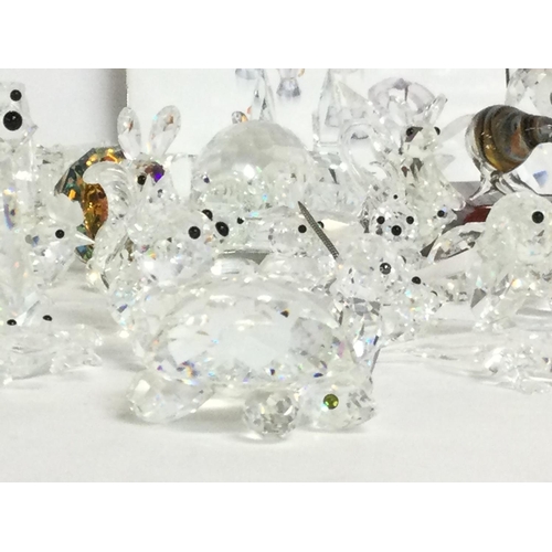 849 - A large collection of various crystal miniature figures including Swarovski, some damage. Postage ca... 