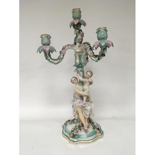 864 - A German porcelain candelabra possible Sitzendourf the stem with a lady a child with raised flowers ... 