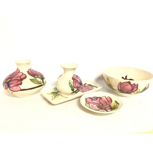 901 - A collection of Moorcroft ivory with pink hibiscus porcelain. Some damage Postage category D