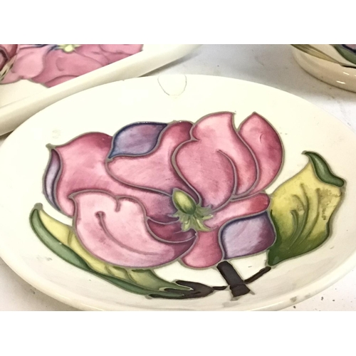 901 - A collection of Moorcroft ivory with pink hibiscus porcelain. Some damage Postage category D