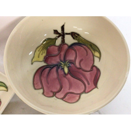 901 - A collection of Moorcroft ivory with pink hibiscus porcelain. Some damage Postage category D