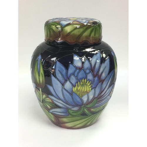 907 - A boxed 2009 Moorcroft ginger jar and cover in blue lotus flower pattern, designed by Rachael Bishop... 