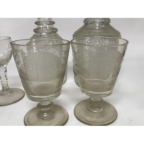 962 - A Collection of glass ware comprising a pair of engraved glasses two decanters and a single wine gla... 