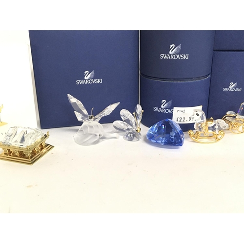 969 - A collection of boxed Swarovski miniature figures , postage category D