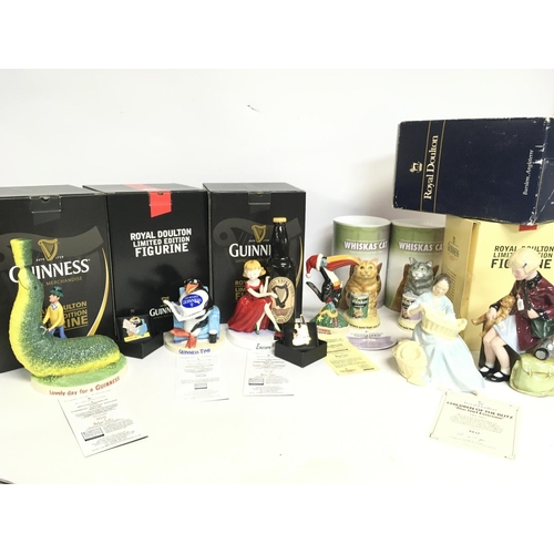 988 - A collection of Royal Doulton ceramics including limited edition Guinness figurines with COAS, Whisk... 