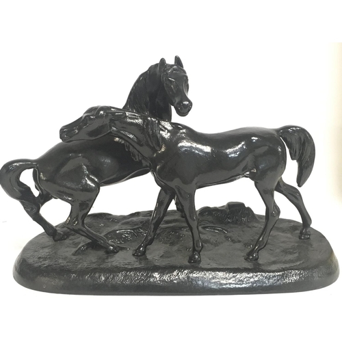 1009 - A Soviet Russian black metal statue of two horses, approximately 24cm wide & 16cm tall. Postage cate... 