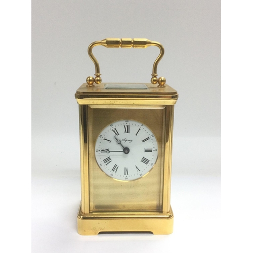 1024 - An Asprey laqcuered brass mantle clock, approx height 18cm including handle. Shipping category D.