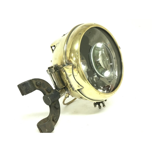 1030 - Early French brass cased spotlight. Cracked glass. Postage category D