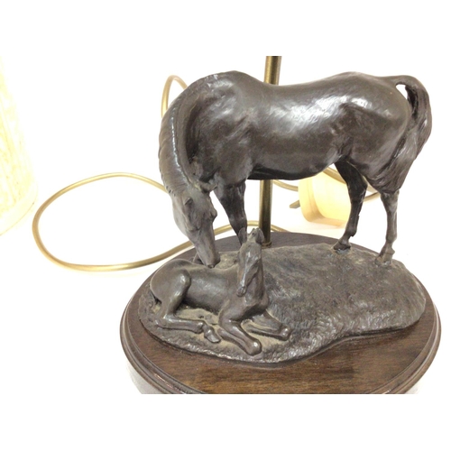 1042 - A bronze lamp with horse and foal. Approximately 35cm high and 23cm wide. Postage C.