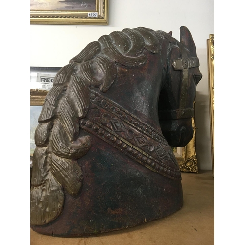 1048 - WITHDRAWN -  A carved horses head with applied brass mounts. Measuring 45cm x 40cm x 20cm approximat... 