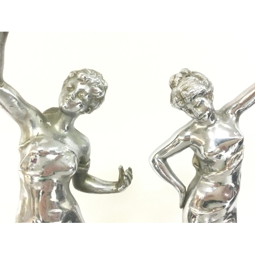 1055 - A pair of chrome Art Deco figures,mounted on marbles bases. Approximately 34cm tall. Postage categor... 