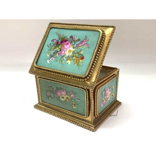 1059 - A French porcelain and gilt metal mounted casket, Tahan Paris, the porcelain panels painted flowers ... 