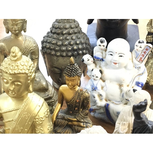 1075 - A collection of Buddha statues, postage cat D