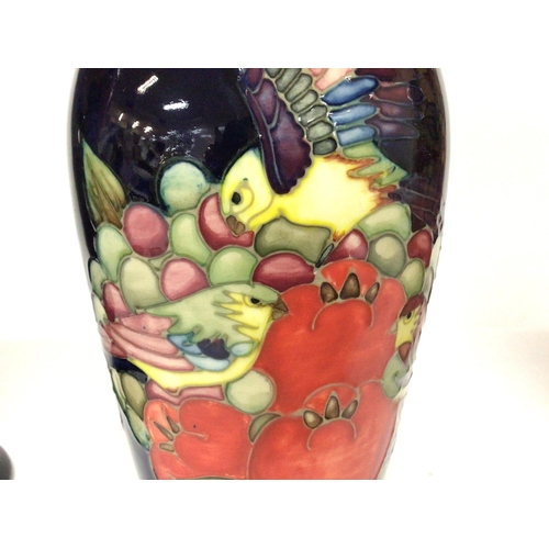 1287 - A collection of Moorcroft with designs of fruit and birds including vases and a lamp, ranging from 1... 