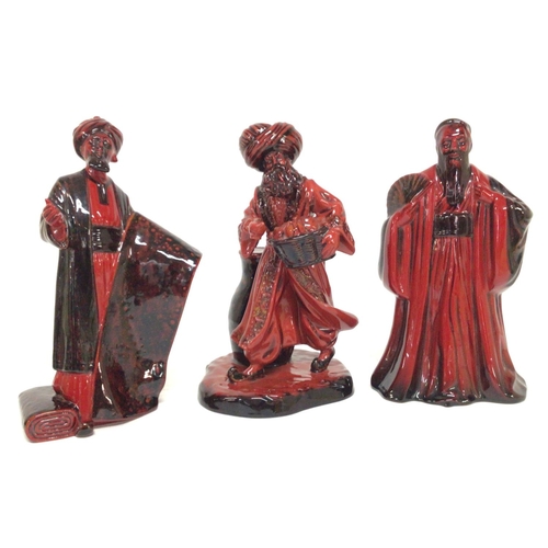 1290 - A collection of Royal Doulton Flambe figurines including The Carpet Seller HN 2776, The Lamp Seller ... 