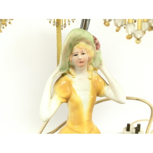 1367 - An Art Deco side lamp surmounted with a porcelain figure of a lady , postage category D