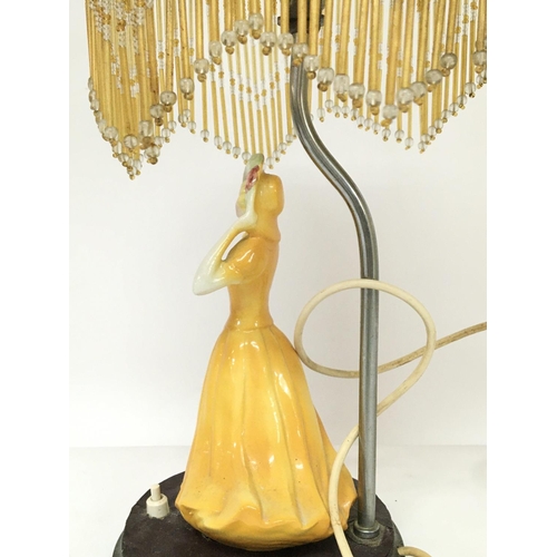 1367 - An Art Deco side lamp surmounted with a porcelain figure of a lady , postage category D