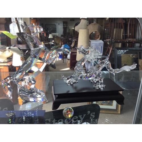 1402 - Two Swarovski figures including rearing horse and Chinese dragon on stand with pearl. Both in fitted... 