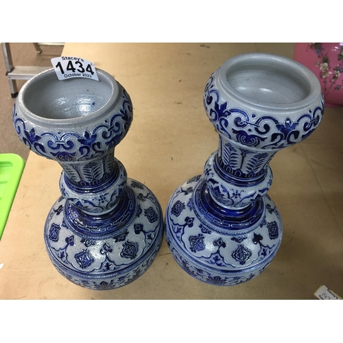 1434 - A pair of German pottery vases on blue ground. Height 33cm