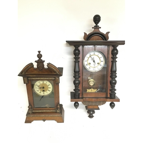 1562 - A Continental wall clock (needs restoring) and one other walnut clock, with keys postage category D.... 