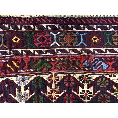 1633 - An unusual patterned rug. 173x105cm. Postage D