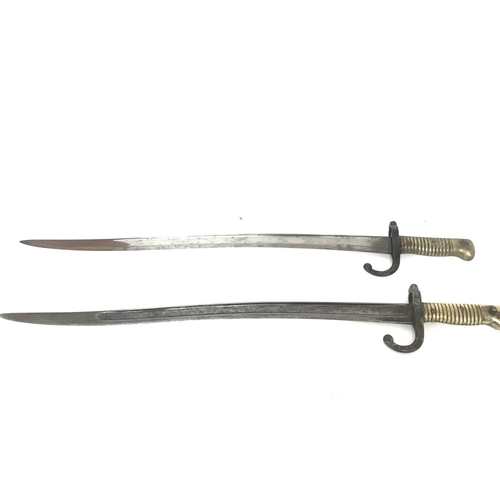 1916 - A pair of French sword bayonets with brass handles dated 1871 & 1874. Approximately 71cm long. Posta... 