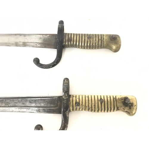 1916 - A pair of French sword bayonets with brass handles dated 1871 & 1874. Approximately 71cm long. Posta... 