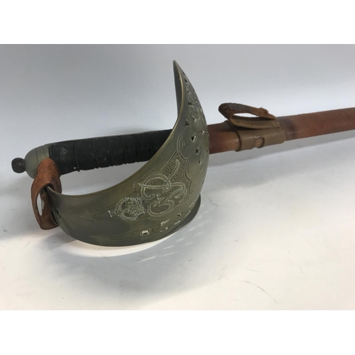 1929 - A cavalry sword with engraved blade and leather scabbard