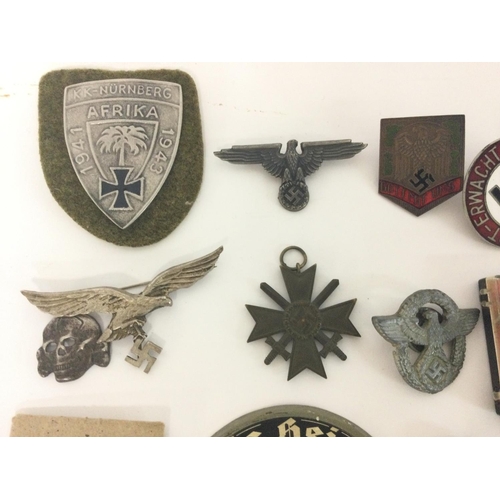 1941 - A collection of reproduction Third Reich pins, badges etc including a leather holster and an SS matc... 