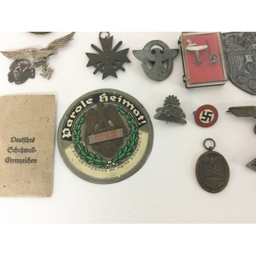 1941 - A collection of reproduction Third Reich pins, badges etc including a leather holster and an SS matc... 