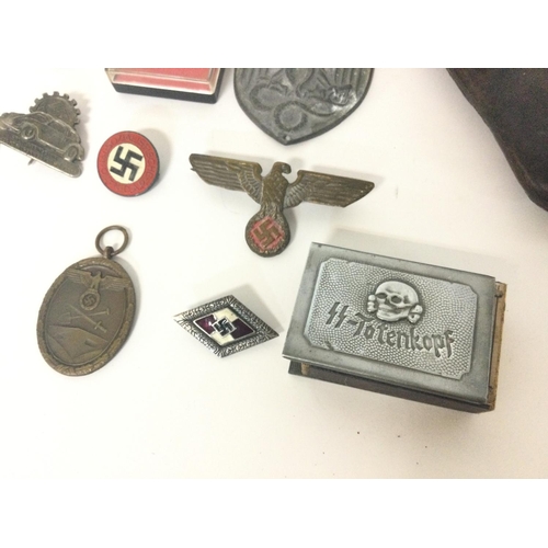 1941 - A collection of reproduction Third Reich pins, badges etc including a leather holster and an SS matc... 