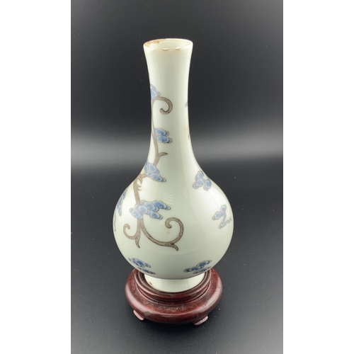 921 - A small Chinese white porcelain bottle bottle vase with hand painted dragon and bat decoration. 14.5... 