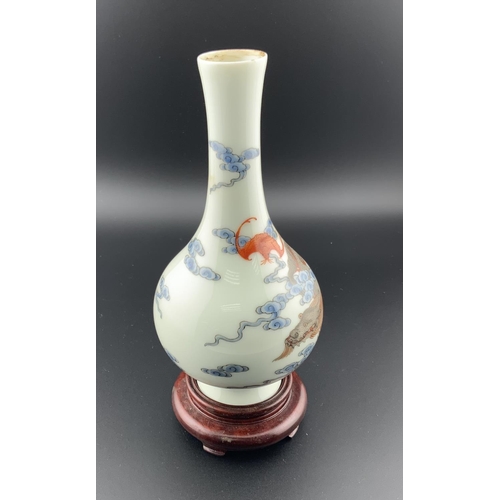 921 - A small Chinese white porcelain bottle bottle vase with hand painted dragon and bat decoration. 14.5... 