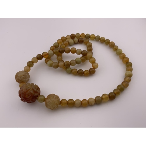 939 - A Chinese hard stone bead necklace. (A)