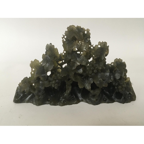 968 - A composition jade type sculpture in the form of grape vine. Length 23cm height 12cm