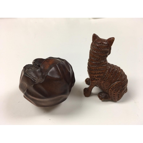 969 - Two carved Netsukes in the form of a cat and an animal inside a cabbage