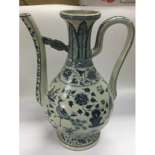 979 - A blue and white ewer decorated in the Oriental taste, approx height 38cm. Shipping category D.