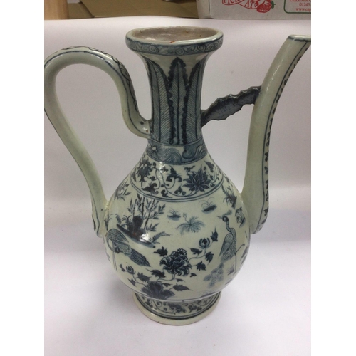 979 - A blue and white ewer decorated in the Oriental taste, approx height 38cm. Shipping category D.