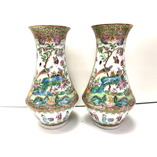 988 - A pair of Cantonese porcelain baluster shaped vases. 25cm (D) some damage to rim.